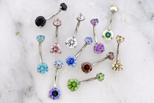 Metal Mafia 316L steel double gem navel rings on white marble