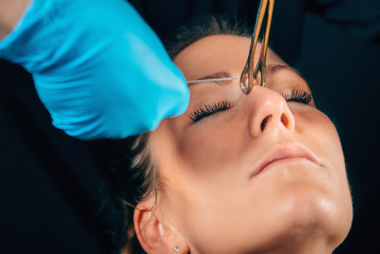 woman getting nose bridge piercing