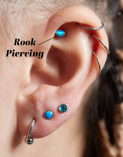 person with rook piercing within their ear curation