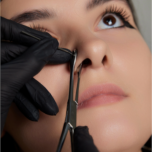 woman getting a nose piercing