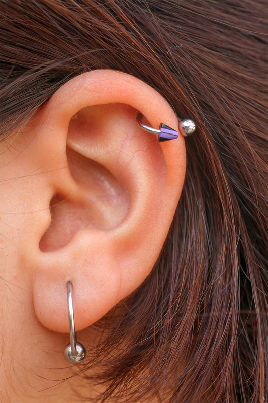 person with two ear piercings
