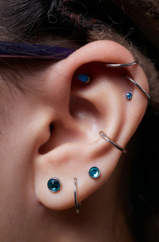a woman wearing many different types of piercing