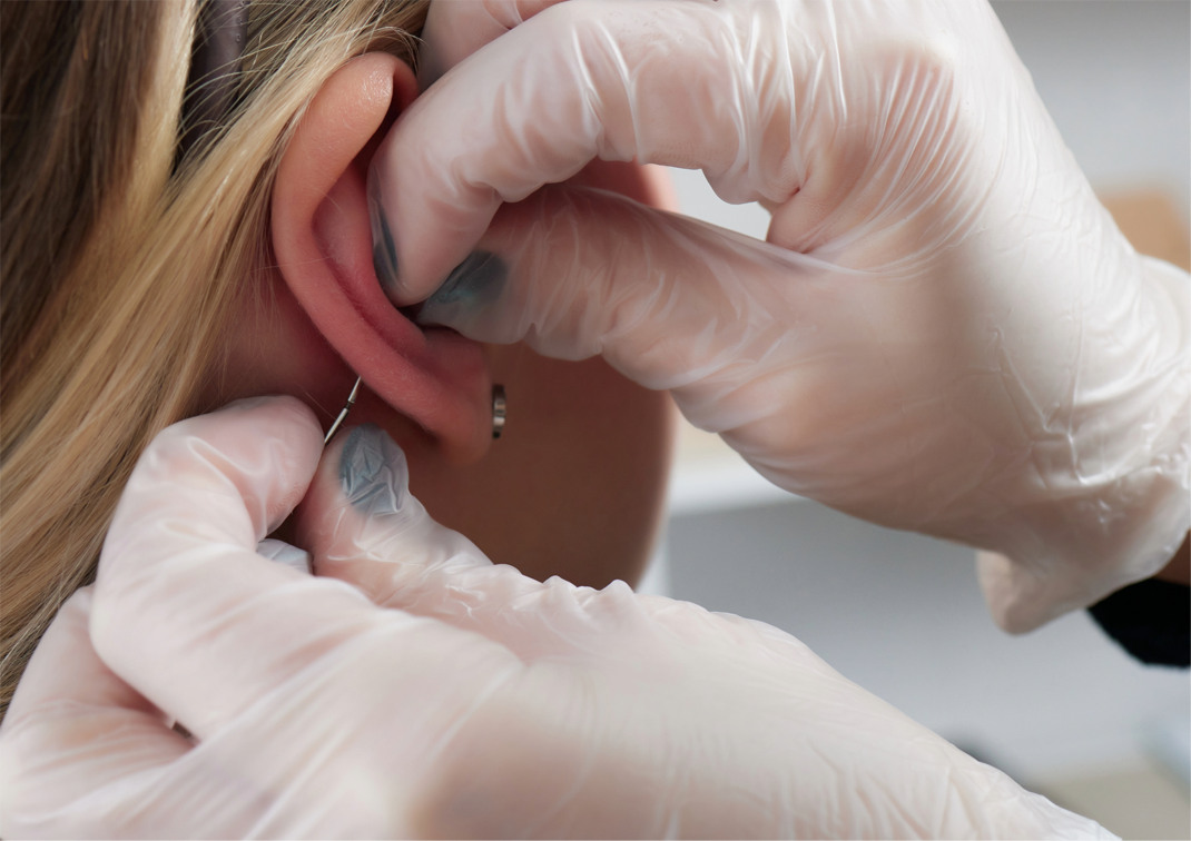 a zoomed-in image of a gold gemstone conch piercing