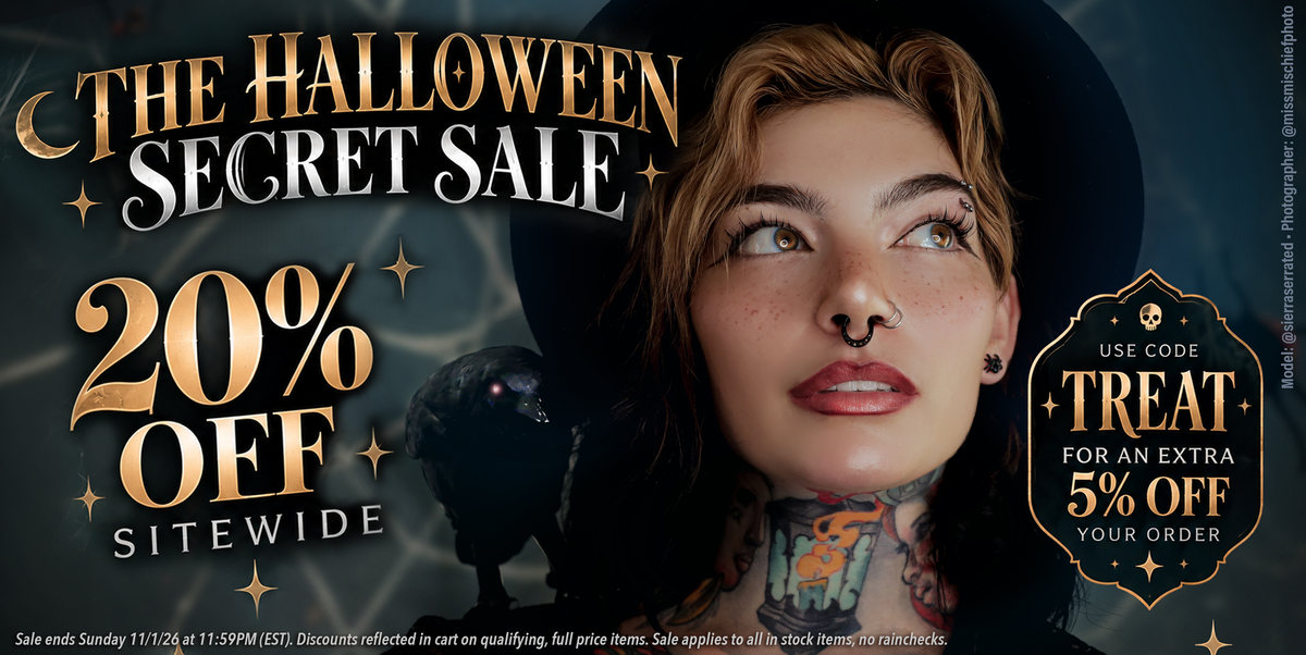 woman with a witch hat and piercings celebrating a halloween sale